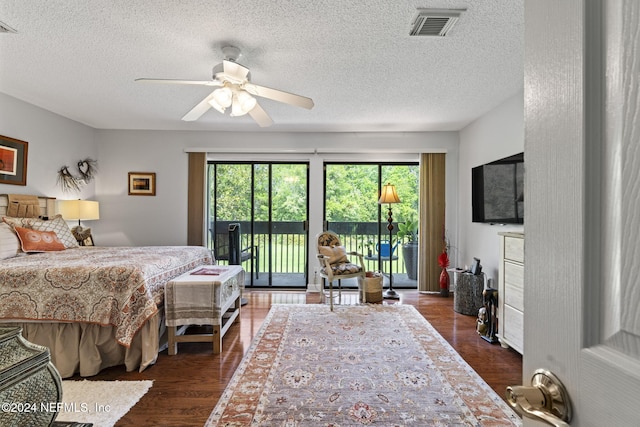 bedroom featuring a textured ceiling, access to outside, ceiling fan, and dark hardwood / wood-style floors