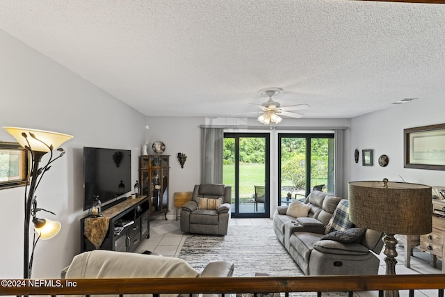 tiled living room featuring ceiling fan and a textured ceiling