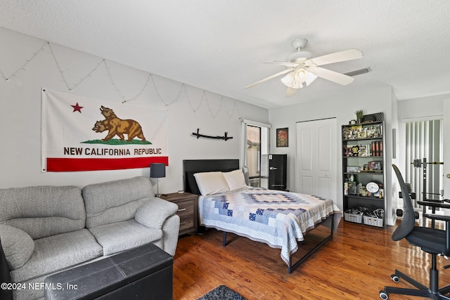 bedroom with multiple windows, ceiling fan, and wood-type flooring