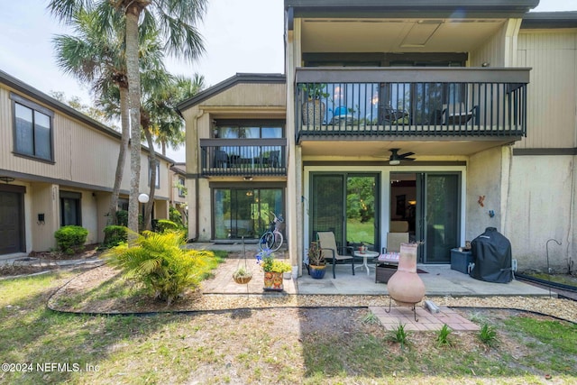 rear view of house featuring ceiling fan, a patio area, and a balcony