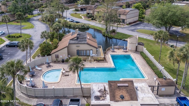 view of swimming pool featuring a water view