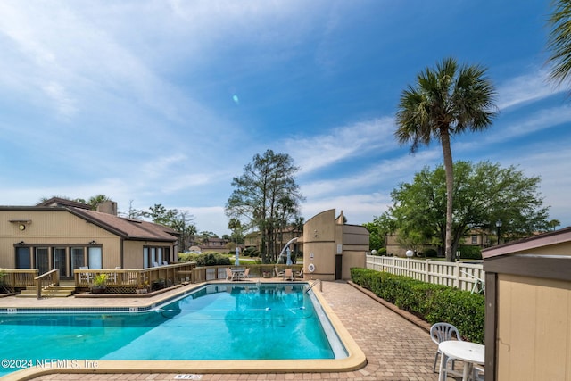 view of swimming pool with a patio and a wooden deck