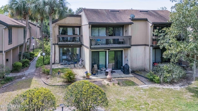 back of house with a patio area and a balcony