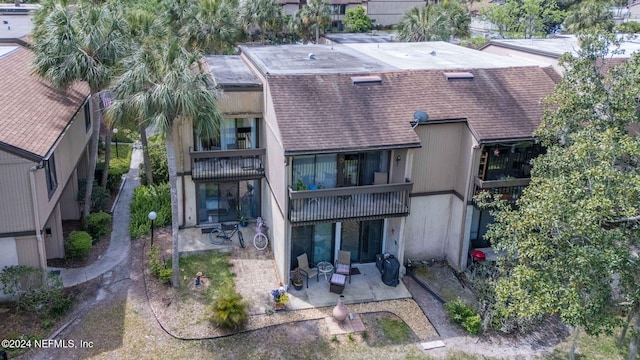 back of property with a patio and a balcony