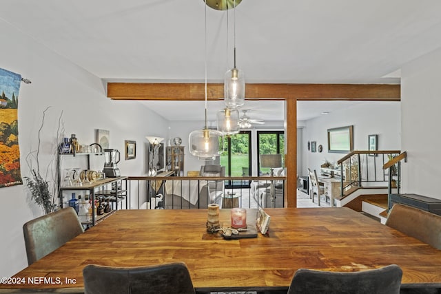 dining space with ceiling fan and beam ceiling