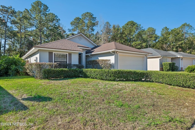 single story home with a front yard and a garage