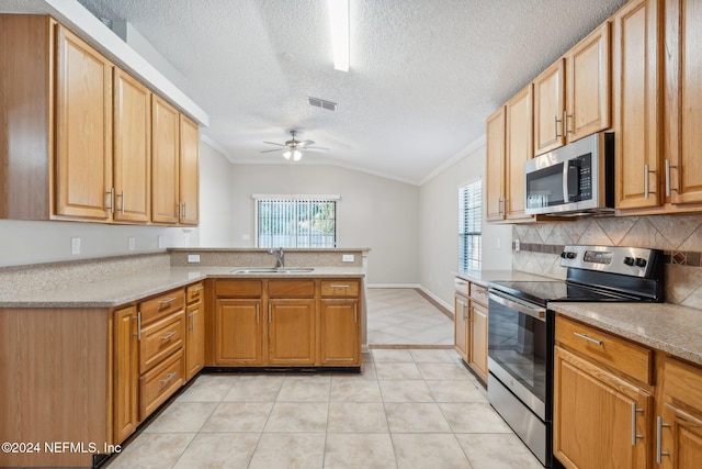 kitchen with kitchen peninsula, ornamental molding, stainless steel appliances, sink, and lofted ceiling