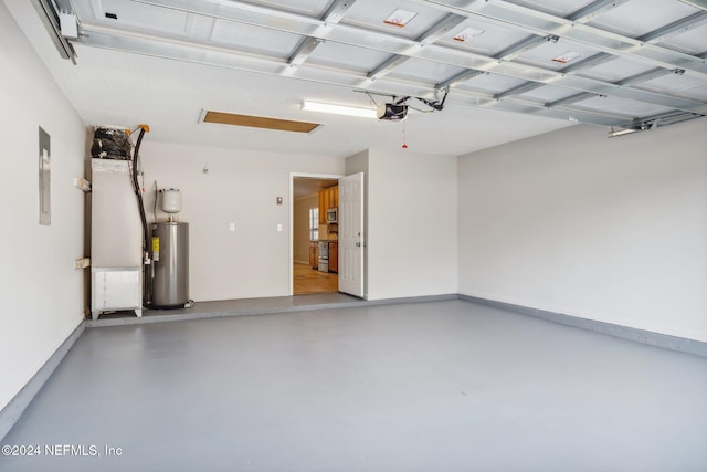 garage featuring electric panel, electric water heater, and a garage door opener