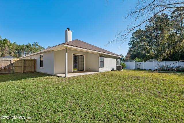 rear view of property with a patio area, a yard, and central AC unit