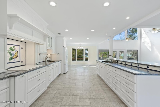 kitchen featuring white cabinets, ceiling fan, white refrigerator, and a wealth of natural light