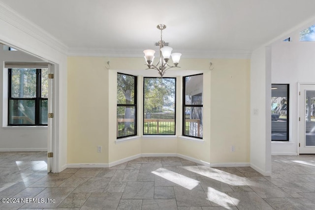 unfurnished dining area with a notable chandelier, a healthy amount of sunlight, and crown molding