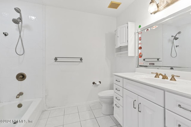 full bathroom featuring tile patterned flooring, vanity, toilet, and tiled shower / bath