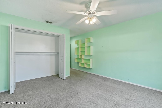 unfurnished bedroom featuring ceiling fan, a closet, and carpet