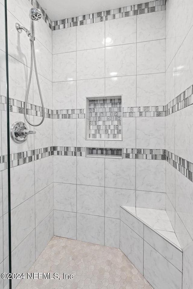 bathroom with tiled shower