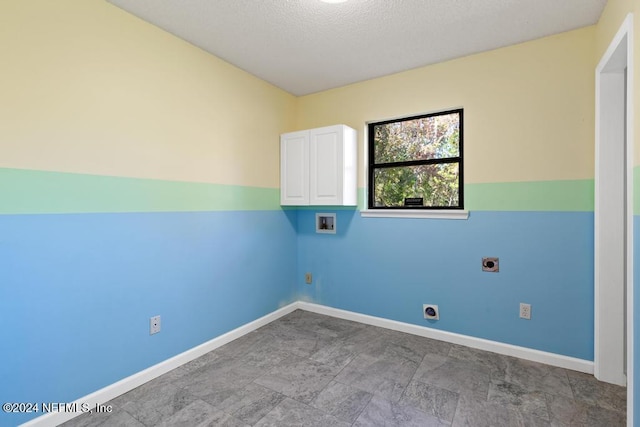 laundry room featuring cabinets, hookup for a washing machine, a textured ceiling, and electric dryer hookup