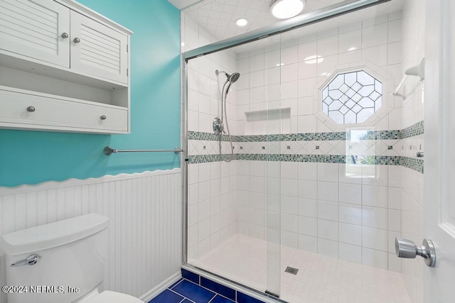 bathroom featuring toilet, tile patterned floors, and walk in shower