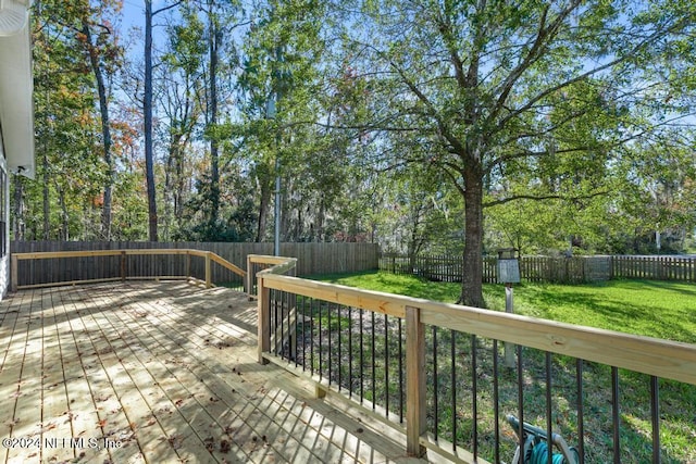 wooden deck featuring a lawn