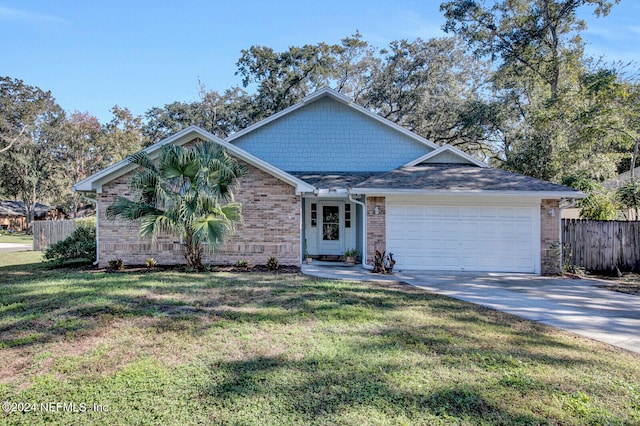 view of front of house with a garage and a front lawn