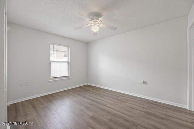 spare room with ceiling fan, hardwood / wood-style floors, and a textured ceiling