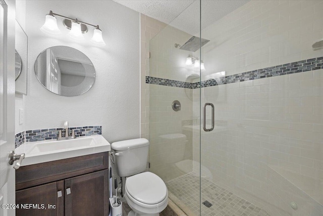 bathroom featuring vanity, toilet, a textured ceiling, and walk in shower