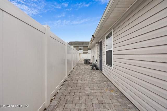 view of side of home featuring a patio area and central AC