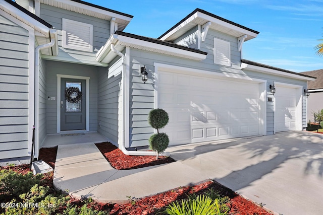 doorway to property with a garage