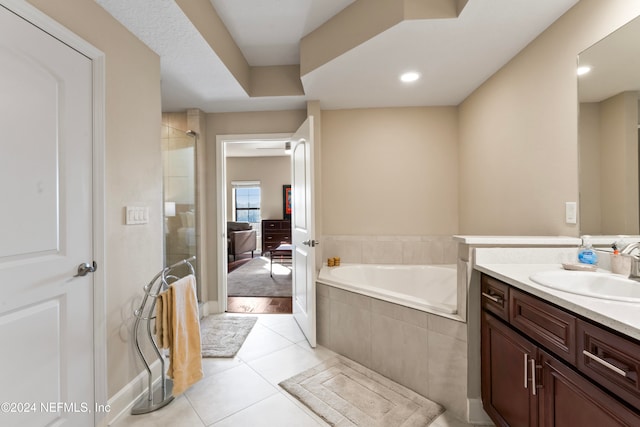 bathroom with tile patterned floors, vanity, and independent shower and bath