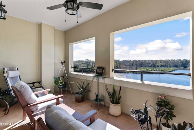 view of patio / terrace with ceiling fan, a water view, and a balcony