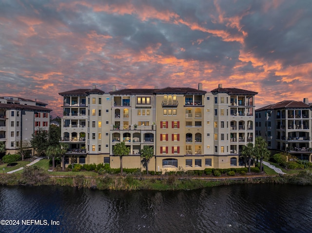 outdoor building at dusk featuring a water view