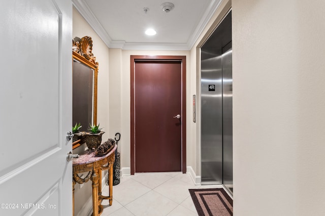 hall featuring elevator, crown molding, and light tile patterned floors