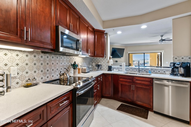 kitchen featuring sink, decorative backsplash, ceiling fan, appliances with stainless steel finishes, and light tile patterned flooring