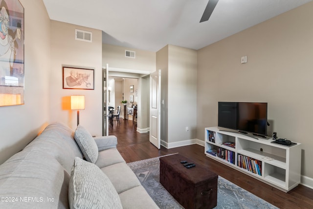 living room with ceiling fan and dark wood-type flooring