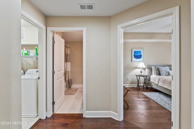 hallway featuring hardwood / wood-style flooring and washer / dryer