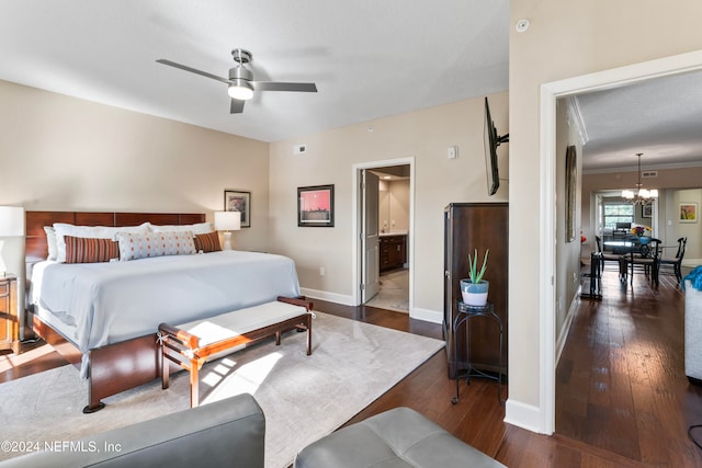 bedroom featuring ensuite bathroom, dark hardwood / wood-style flooring, and ceiling fan with notable chandelier