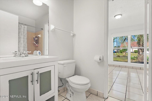 bathroom featuring curtained shower, tile patterned flooring, a textured ceiling, toilet, and vanity