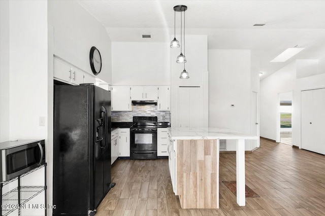 kitchen featuring white cabinets, pendant lighting, wood-type flooring, and black appliances