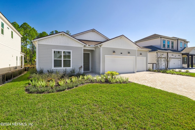 view of front of home featuring a front lawn and a garage