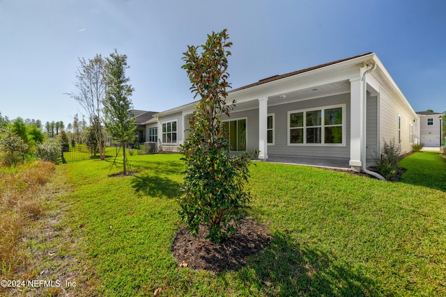 rear view of property featuring a yard