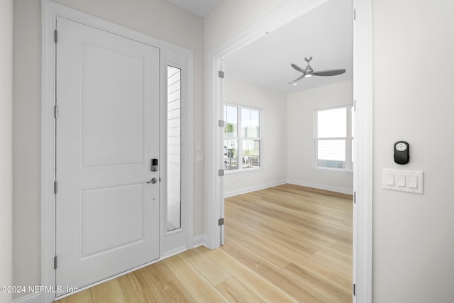 foyer with light wood-type flooring and ceiling fan