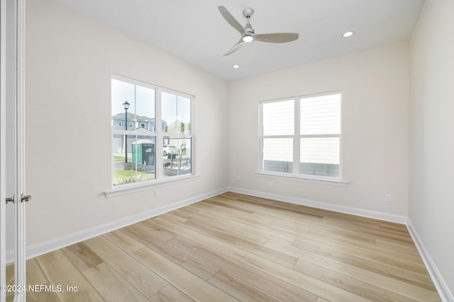 empty room with light wood-type flooring and ceiling fan