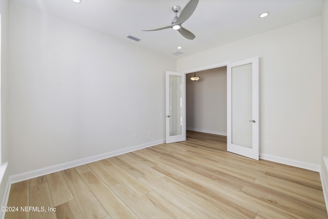 empty room featuring french doors, light hardwood / wood-style flooring, and ceiling fan