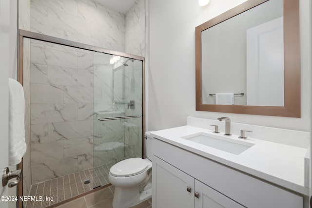 bathroom featuring tile patterned floors, vanity, toilet, and walk in shower