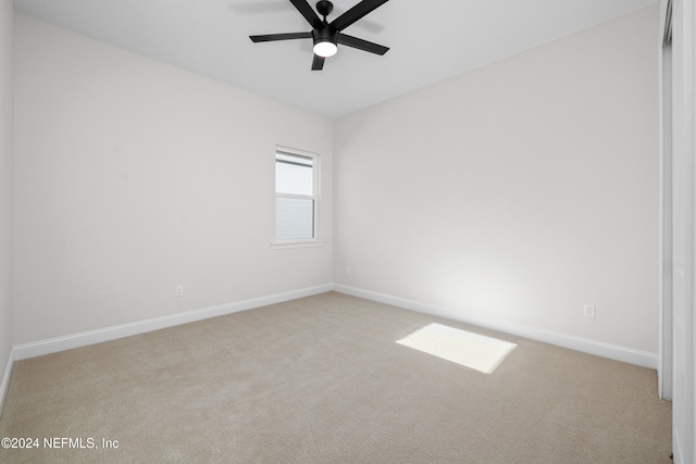 unfurnished room with ceiling fan and light colored carpet