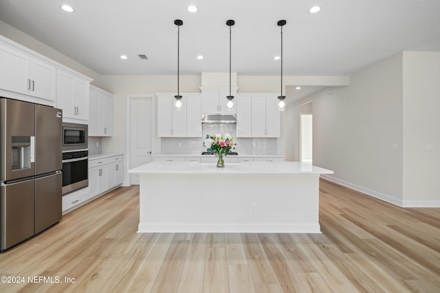 kitchen with appliances with stainless steel finishes, light wood-type flooring, decorative light fixtures, white cabinets, and a kitchen island