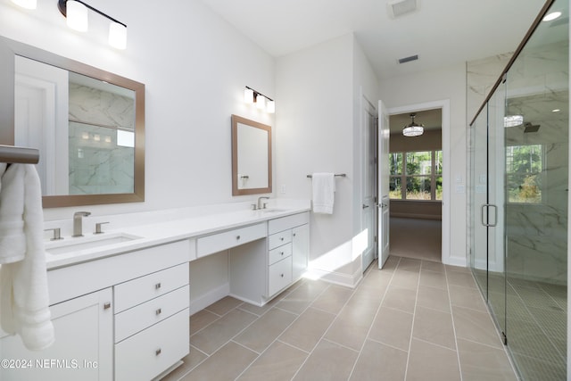 bathroom featuring a shower with door, vanity, and tile patterned flooring