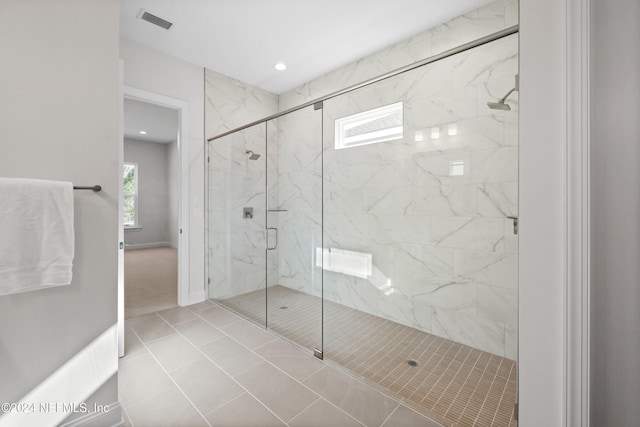 bathroom featuring tile patterned flooring and an enclosed shower