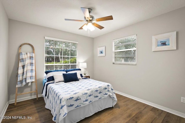 bedroom with ceiling fan and dark hardwood / wood-style flooring