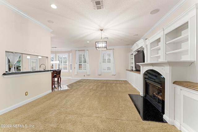 unfurnished living room featuring light colored carpet, a textured ceiling, and ornamental molding