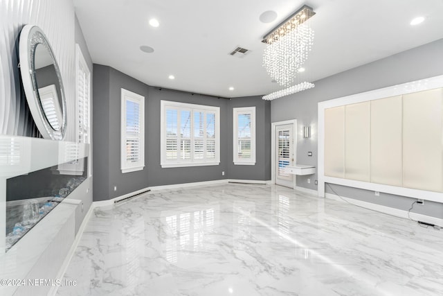 unfurnished living room with an inviting chandelier