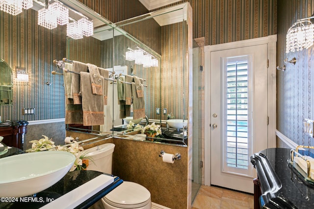 bathroom featuring a chandelier, toilet, and sink